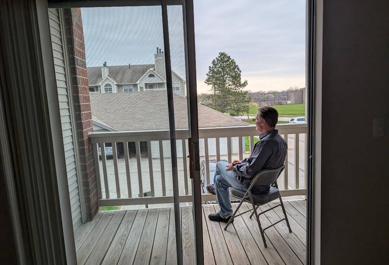 Veteran on Balcony of his Apartment